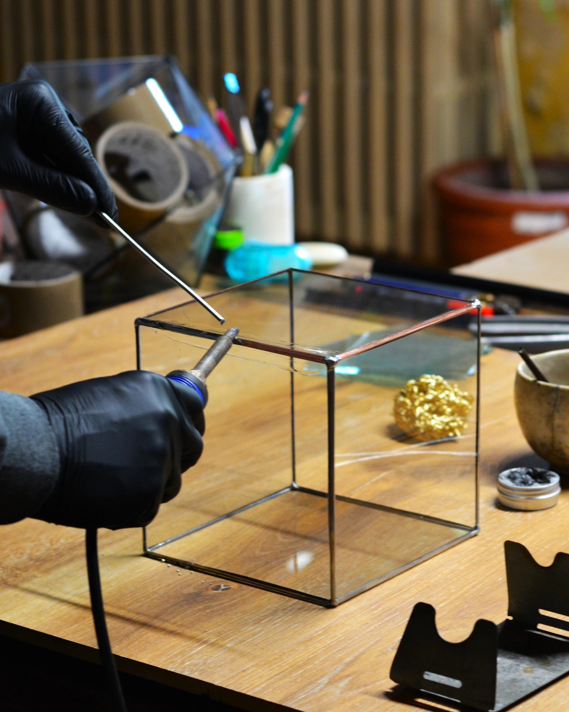 Cube being soldered, in the workshop