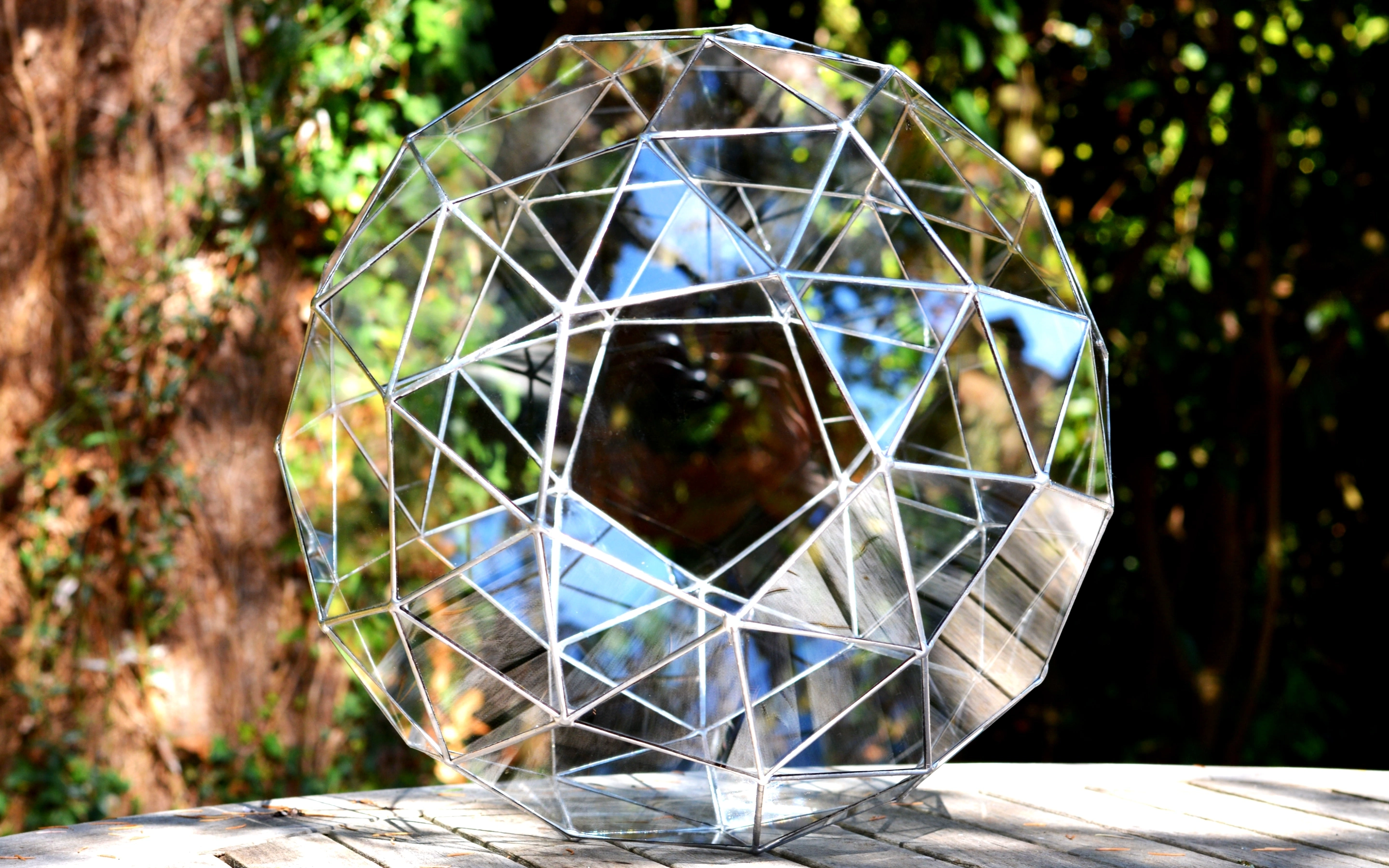 Snub dodecahedron Solar in clear glass, resting outdoors