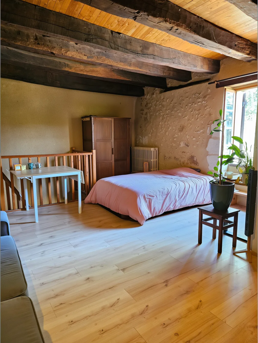 The participants' room: bed, antique wardrobe and light wooden floor