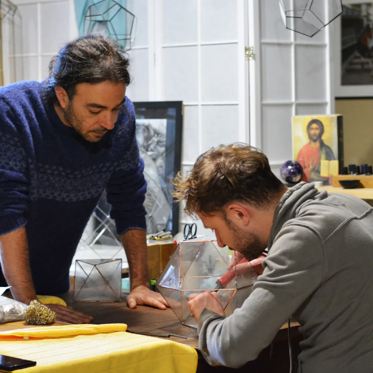 Boris and a participant soldering an icosahedron in the workshop